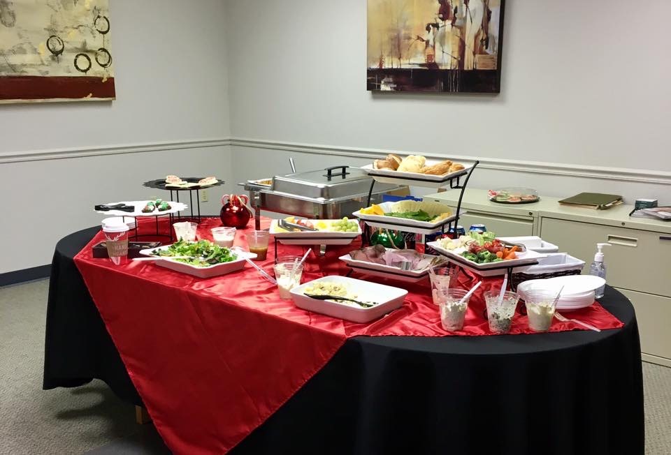 Corporate catering buffet setup with food and tableware