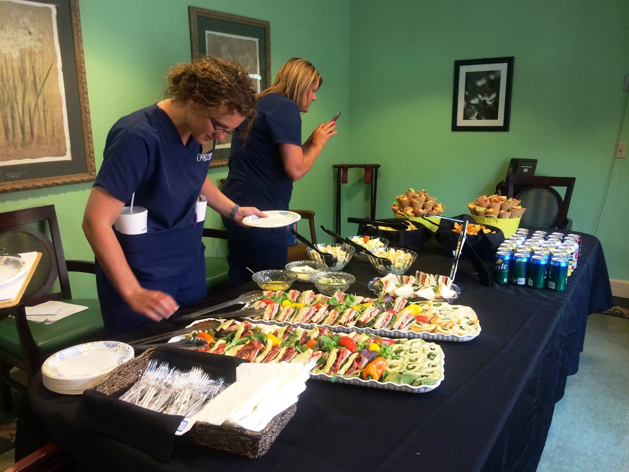 Corporate catering buffet spread with sandwiches and salads