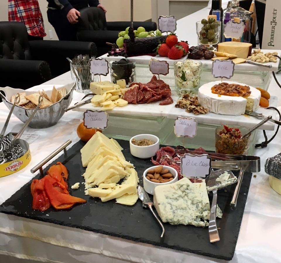 Elaborate charcuterie and cheese board spread at a corporate event