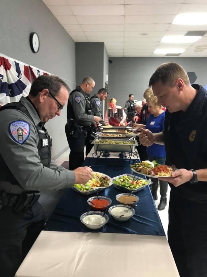Police officers and community members serving themselves at a catered buffet