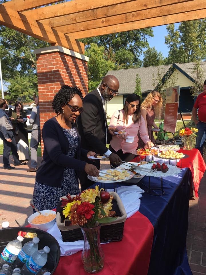 Guests serving themselves from an outdoor buffet