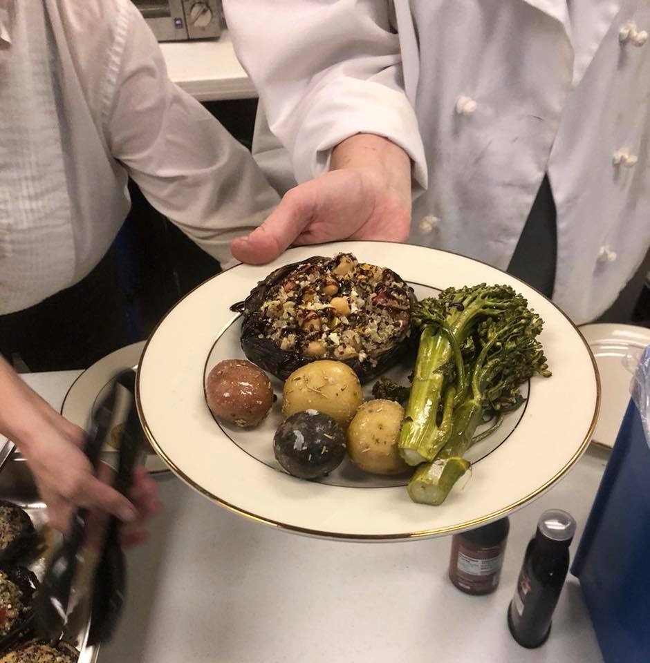 Catered plate with stuffed portobello mushroom, baby potatoes, and broccolini