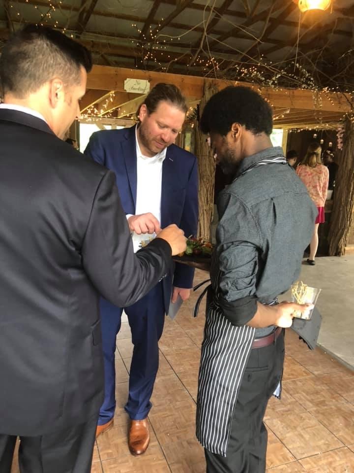 Catering staff serving guests appetizers at a wedding reception