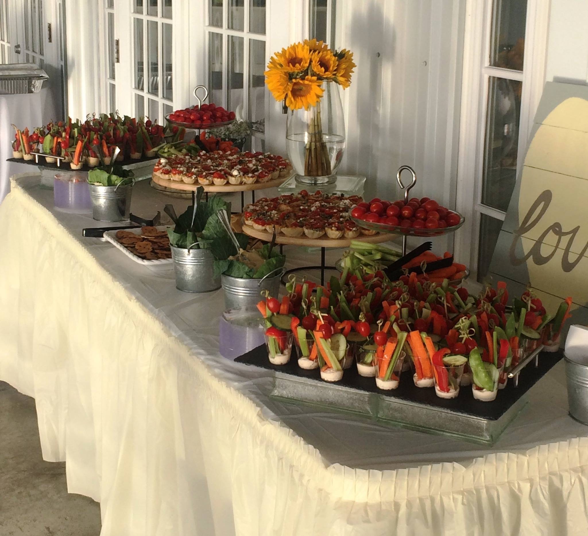 Catering buffet table with appetizers and vegetable cups
