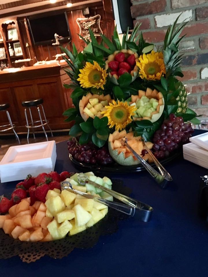 Elaborate fruit and vegetable display at a wedding catering event